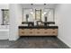 Modern bathroom with double sinks, dark herringbone floors and a walk-in shower at 8200 N Charles Dr, Paradise Valley, AZ 85253