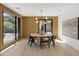 Modern dining room features a round table, six chairs, and large windows with mountain views at 8200 N Charles Dr, Paradise Valley, AZ 85253