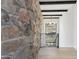 Modern interior with stone wall, light wood floors, and a view at 8200 N Charles Dr, Paradise Valley, AZ 85253