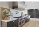 Modern kitchen with stainless steel appliances and dark wood cabinetry at 8200 N Charles Dr, Paradise Valley, AZ 85253