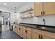 Laundry room with light wood cabinets and dark countertops at 8200 N Charles Dr, Paradise Valley, AZ 85253