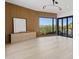 Bright living room featuring wood floors, mountain views, and modern wall paneling at 8200 N Charles Dr, Paradise Valley, AZ 85253