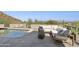 Relaxing pool area with sectional sofa and mountain views at 8200 N Charles Dr, Paradise Valley, AZ 85253