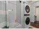 Bathroom with shower/tub combo, white subway tile, and stacked washer/dryer at 8241 N Central Ave # 32, Phoenix, AZ 85020