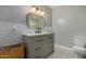 Clean bathroom with gray vanity, white subway tile, and a herringbone floor at 8241 N Central Ave # 32, Phoenix, AZ 85020