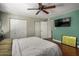 Main bedroom with wood floors, ceiling fan, and large closet at 8241 N Central Ave # 32, Phoenix, AZ 85020