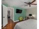 Spacious bedroom with wood floors, a ceiling fan, and built-in workspace at 8241 N Central Ave # 32, Phoenix, AZ 85020