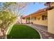 Artificial turf and covered patio, creating a relaxing outdoor space at 8766 W Desert Trl, Peoria, AZ 85381