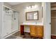 Bathroom with walk-in shower and wood vanity at 8766 W Desert Trl, Peoria, AZ 85381