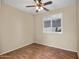 Bright bedroom with wood-look floors and ceiling fan at 8766 W Desert Trl, Peoria, AZ 85381