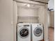 Laundry room with washer, dryer, and shelving at 8766 W Desert Trl, Peoria, AZ 85381