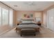 Primary bedroom with staged furniture and wood-look floors at 8841 W Cordes Rd, Tolleson, AZ 85353