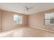 Bright bedroom featuring wood-look floors and a ceiling fan at 8841 W Cordes Rd, Tolleson, AZ 85353