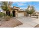 Two-story house with tan exterior, arched entryway, and two-car garage at 8841 W Cordes Rd, Tolleson, AZ 85353