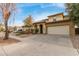 Tan two-story house with arched entryway, landscaping, and two-car garage at 8841 W Cordes Rd, Tolleson, AZ 85353