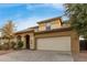 Two-story house with tan exterior, arched entryway, and attached two-car garage at 8841 W Cordes Rd, Tolleson, AZ 85353