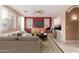 Living room with red accent wall, tiled floors, and plenty of natural light at 8841 W Cordes Rd, Tolleson, AZ 85353