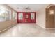 Living room with red accent wall and tiled floors at 8841 W Cordes Rd, Tolleson, AZ 85353