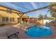 Backyard oasis featuring a refreshing pool and pergola at 8841 W Cordes Rd, Tolleson, AZ 85353