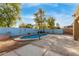 Inviting kidney-shaped pool with wooden pergola at 8841 W Cordes Rd, Tolleson, AZ 85353