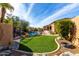 Landscaped backyard oasis with a sparkling pool, lush grass, and a relaxing atmosphere at 9535 E Mclellan Rd, Mesa, AZ 85207