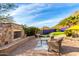 Outdoor patio with fireplace, seating area, and mountain views at 9535 E Mclellan Rd, Mesa, AZ 85207