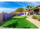 Landscaped backyard with putting green and purple wall at 9535 E Mclellan Rd, Mesa, AZ 85207