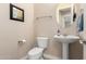 Clean and updated bathroom with pedestal sink and toilet at 9535 E Mclellan Rd, Mesa, AZ 85207