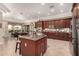 Open concept kitchen with large island, stainless steel appliances, and dark wood cabinets at 9535 E Mclellan Rd, Mesa, AZ 85207