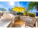 Relaxing outdoor kitchen area with built-in grill and patio seating at 9535 E Mclellan Rd, Mesa, AZ 85207