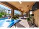 Covered patio with seating area, ping pong table, and a large TV at 9535 E Mclellan Rd, Mesa, AZ 85207