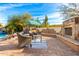 Relaxing poolside patio with seating and a fire pit at 9535 E Mclellan Rd, Mesa, AZ 85207