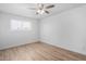 Bedroom with ceiling fan, window, and wood-look floors at 9676 W Mountain View Rd # B, Peoria, AZ 85345