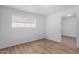 Bright bedroom featuring wood-look floors and window coverings at 9676 W Mountain View Rd # B, Peoria, AZ 85345