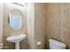 Small bathroom with pedestal sink and toilet at 10406 E Laguna Azul Ave, Mesa, AZ 85209