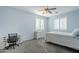 Light and bright bedroom with a ceiling fan and window shutters at 10406 E Laguna Azul Ave, Mesa, AZ 85209