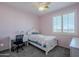 Bedroom with twin bed, desk and chair, window with shutters at 10406 E Laguna Azul Ave, Mesa, AZ 85209