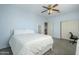 Bedroom with queen bed, ceiling fan, and access to upper floor at 10406 E Laguna Azul Ave, Mesa, AZ 85209