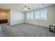 Spacious bonus room with gray carpet and ceiling fan at 10406 E Laguna Azul Ave, Mesa, AZ 85209