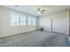 Bright bonus room with gray carpet, ceiling fan and window shutters at 10406 E Laguna Azul Ave, Mesa, AZ 85209