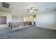 Large bonus room with gray carpet, ceiling fan and loft overlook at 10406 E Laguna Azul Ave, Mesa, AZ 85209