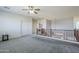 Spacious bonus room with gray carpet, ceiling fan and loft overlook at 10406 E Laguna Azul Ave, Mesa, AZ 85209