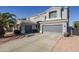 Two-story house with a large driveway and desert landscaping at 10406 E Laguna Azul Ave, Mesa, AZ 85209