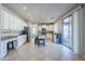 Bright kitchen featuring white cabinets, granite counters, and a breakfast bar at 10406 E Laguna Azul Ave, Mesa, AZ 85209