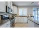 Kitchen features granite counters, stainless steel appliances, and white cabinets at 10406 E Laguna Azul Ave, Mesa, AZ 85209