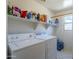 Laundry room with washer, dryer, and shelving for storage at 10406 E Laguna Azul Ave, Mesa, AZ 85209