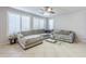 Living room with L-shaped sofa and large windows at 10406 E Laguna Azul Ave, Mesa, AZ 85209