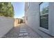 Side yard with gravel landscaping and a walkway to the back at 10406 E Laguna Azul Ave, Mesa, AZ 85209