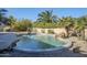 Relaxing kidney shaped pool with a waterfall feature in the backyard at 10406 E Laguna Azul Ave, Mesa, AZ 85209