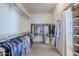 Spacious walk-in closet with custom shelving and hanging rods at 10406 E Laguna Azul Ave, Mesa, AZ 85209